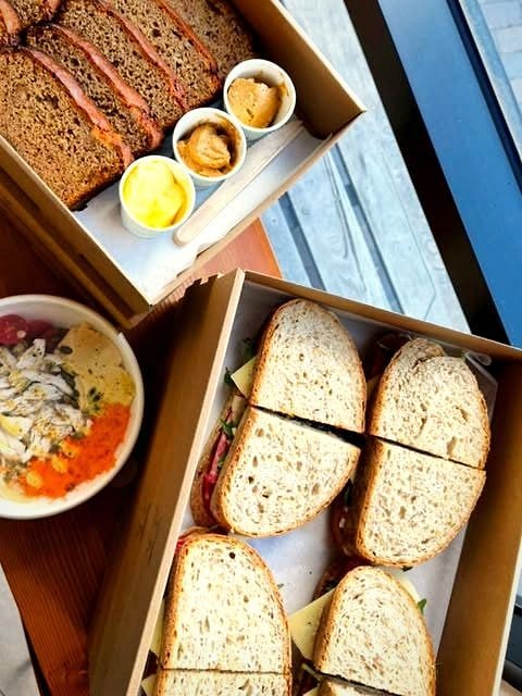 Homeland Cafe lunch boxes packed with sandwiches and fresh bowls