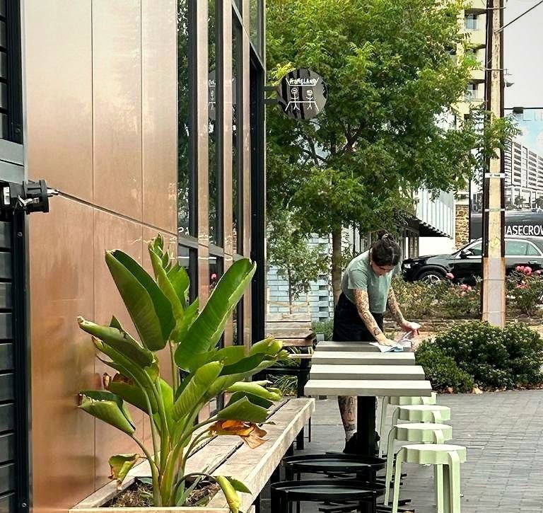 The Homeland Cafe corner at 1 King William Street, Kent Town, with outdoor tables and greenery